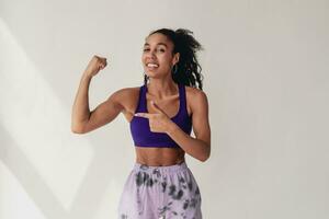 attractive black african american woman posing in stylish hipster outfit on white background photo