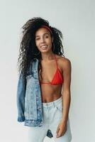 attractive black african american woman posing in stylish hipster outfit on white background photo