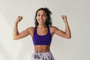 attractive black african american woman posing in stylish hipster outfit on white background photo