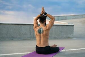 attractive hansome man with athletic strong body doing morning yoga dzen meditation photo