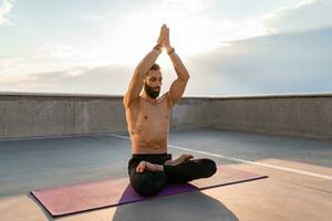 attractive hansome man with athletic strong body doing morning yoga dzen meditation photo