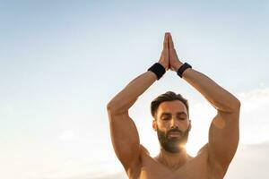 attractive hansome man with athletic strong body doing morning yoga dzen meditation photo