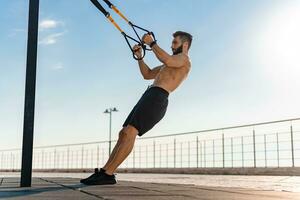 attractive hansome man shirtless with athletic strong body on morning fitness workout exercise photo