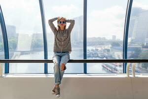 young hipster woman in casual outfit having fun listening to music photo