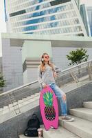 young hipster woman in street with balance board photo