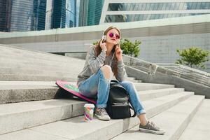 young hipster woman in street with balance board photo