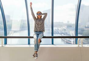 young hipster woman dancing having fun in urban photo