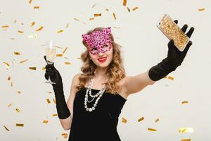 young stylish woman on white background drinking champagne photo