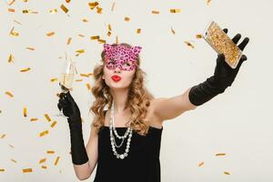 young stylish woman on white background drinking champagne photo