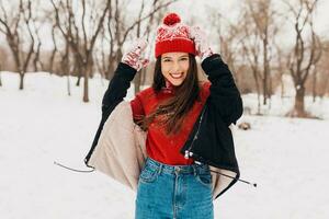 smiling woman having fun in winter park photo