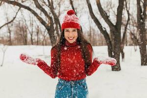 smiling woman having fun in winter park photo