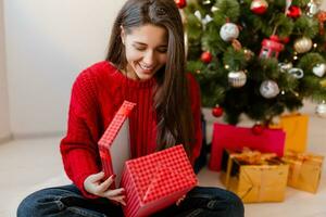 pretty woman at christmas tree with presents photo