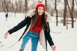 smiling woman having fun in winter park photo