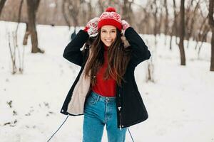 smiling woman having fun in winter park photo