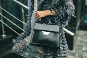 stylish woman in winter fur coat walking in street photo