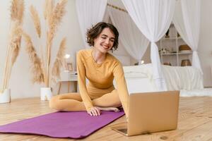 young pretty woman doing yoga at home photo