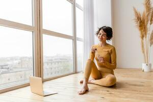 young pretty woman doing yoga at home photo