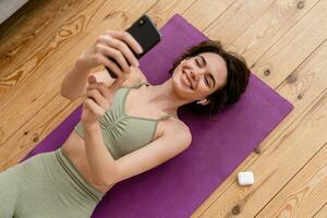 young pretty woman doing yoga at home photo