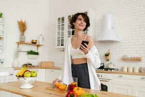 young pretty woman cooking at home, morning kitchen, healthy food photo