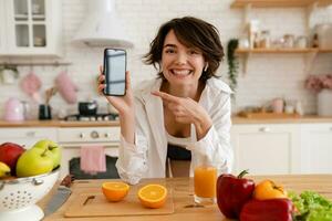 young pretty woman cooking at home, morning kitchen, healthy food photo