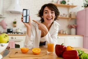 young pretty woman cooking at home, morning kitchen, healthy food photo