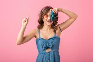 attractive smiling happy woman posing with vintage photo camera