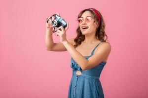 attractive smiling happy woman posing with vintage photo camera