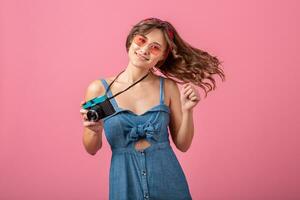 attractive smiling happy woman posing with vintage photo camera