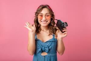 attractive smiling happy woman posing with vintage photo camera