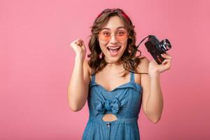 attractive smiling happy woman posing with vintage photo camera