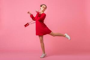 attractive happy smiling stylish woman in red trendy dress photo