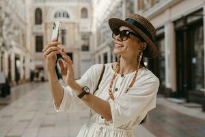 attractive woman walking in shopping street in Italy on vacation dressed in white summer fashion dress photo