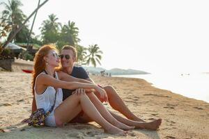 young couple in love happy on summer beach together having fun photo