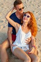 young couple in love happy on summer beach together having fun photo