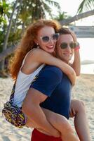 young couple in love happy on summer beach together having fun photo