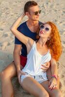 young couple in love happy on summer beach together having fun photo