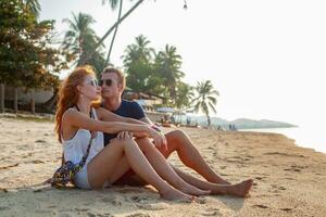 young couple in love happy on summer beach together having fun photo