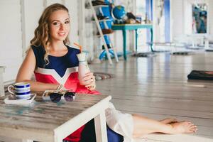 young stylish beautiful woman in cafe photo