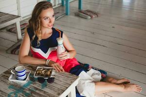 young stylish beautiful woman in cafe photo