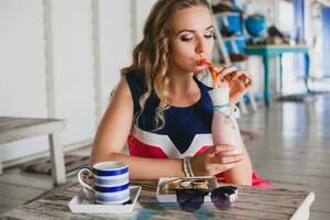 young stylish beautiful woman in cafe photo