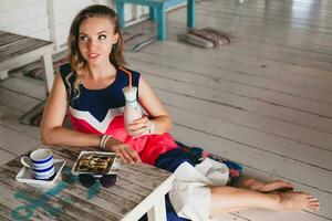 young stylish beautiful woman in cafe photo