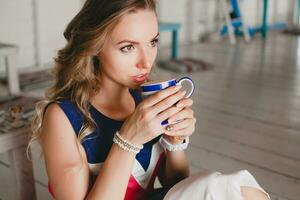 young stylish beautiful woman in cafe photo