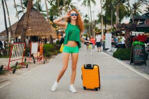 woman traveler with orange suitcase, traveling around world photo