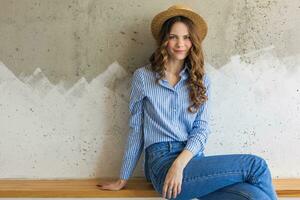 portrait of young pretty woman with straw hat jeans blue cotton shirt photo