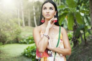 young sexy beautiful woman in colorful dress, summer hippie style photo