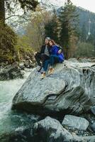 young hipster couple in love on winter vacation in mountains photo