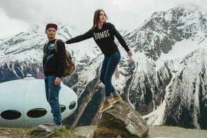 young hipster couple in love on winter vacation in mountains photo