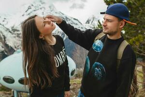 young hipster couple in love on winter vacation in mountains photo