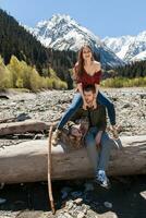 young hipster couple in love on winter vacation in mountains photo