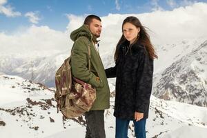 young beautiful hipster couple hiking in mountains photo